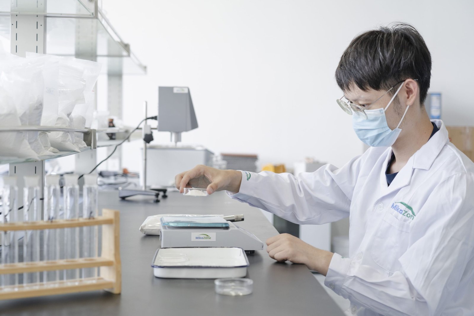 Engineer testing upgraded building material performance in laboratory