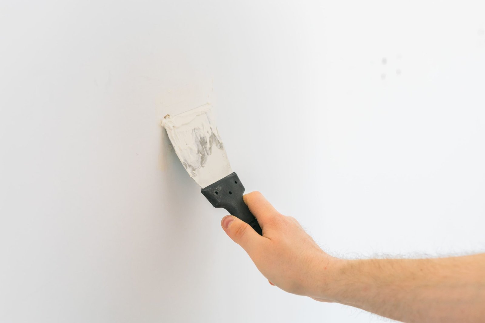 Smooth plaster or compound being spread on a wall