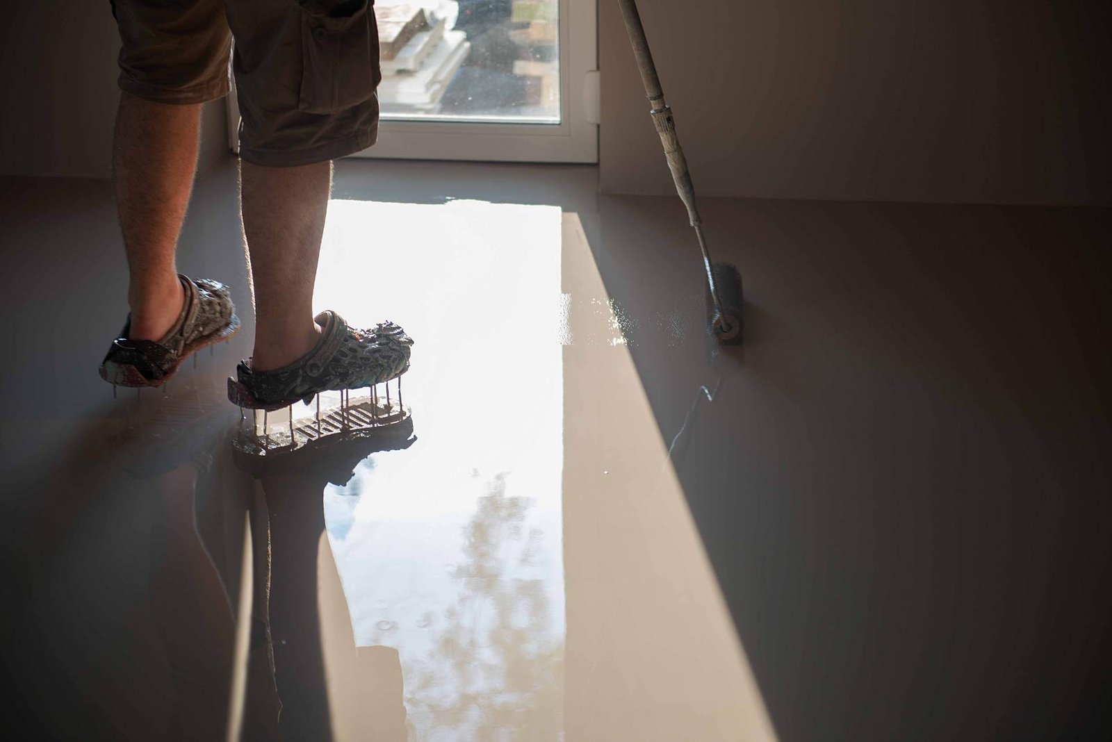 Self-leveling compound being poured on a floor